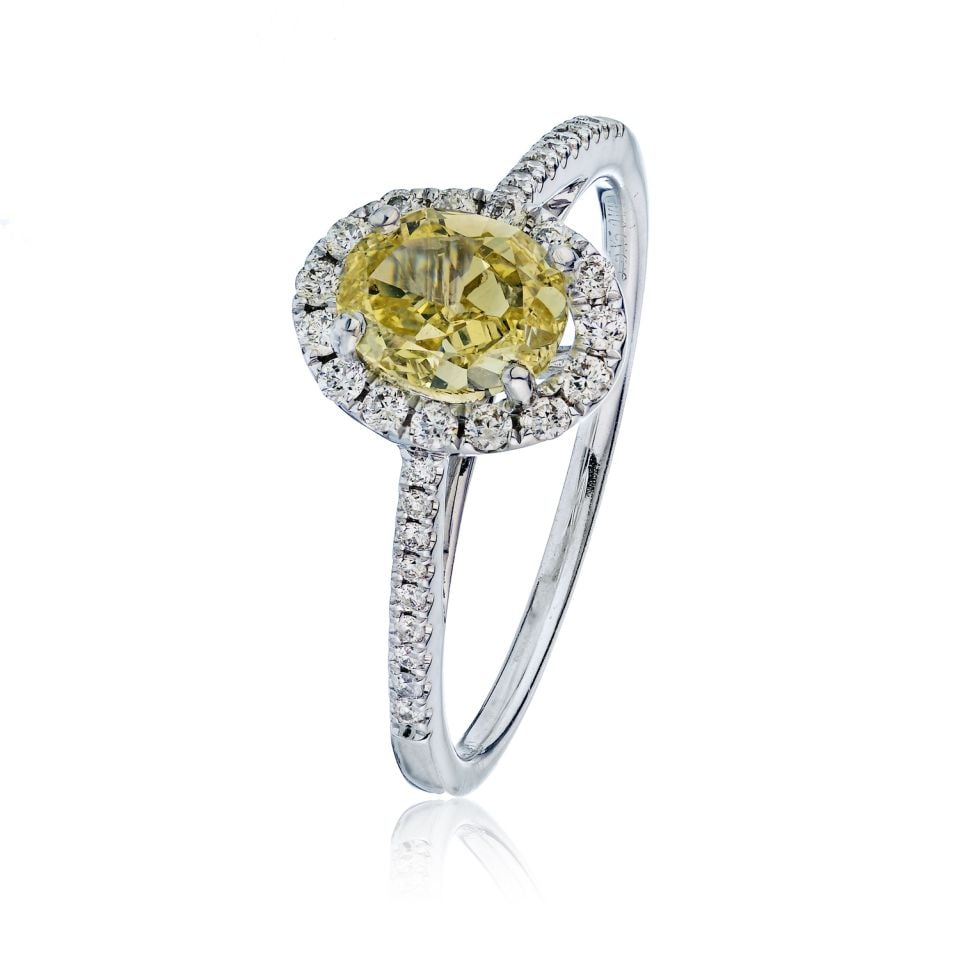 0.90 Carat GIA Certified Oval Fancy Yellow Diamond Halo Ring in 14K White Gold: 0.90 Carat GIA Certified Oval Fancy Yellow Diamond Halo Ring in 14K White Gold This stunning Fancy Yellow ring features a 0.90 carat oval diamond certified by GIA, showcasing a beautiful SI1 clarity. 