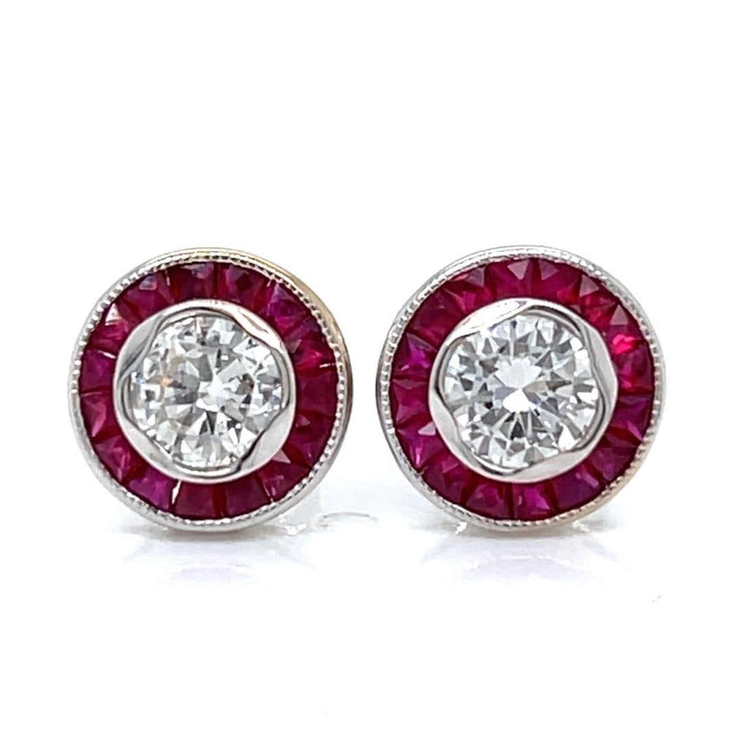 Diamond and Ruby Stud Earrings in 18K White Gold: Diamond and Ruby Stud Earrings in 18K White Gold These elegant stud earrings are crafted from 18K white gold and feature a total weight of 2.4 grams. Each earring is set with a diamond, totaling 0.76 