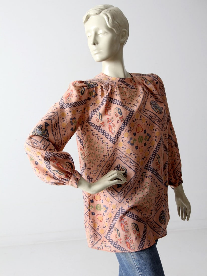 1970s Rene Kasmet California Boho Print Blouse Peach Color: 1970s Rene Kasmet California Boho Print Blouse Peach Color Step back in time with this stunning 1970s vintage boho print blouse by Rene Kasmet California. This delightful peach top features long puffe