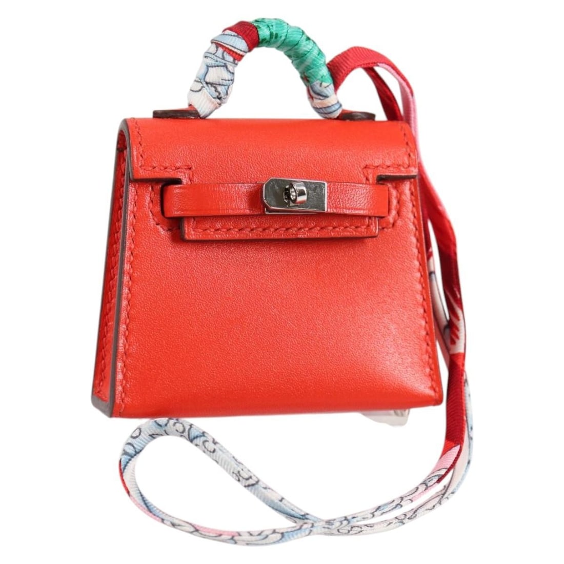 HERMES Micro Kelly Bag Charm Leather Orange Made in France: HERMES Micro Kelly Bag Charm Leather Orange Made in France This exquisite HERMES Micro Kelly Bag Charm is a stunning accessory crafted from high-quality leather in a vibrant orange hue. Perfect for ad