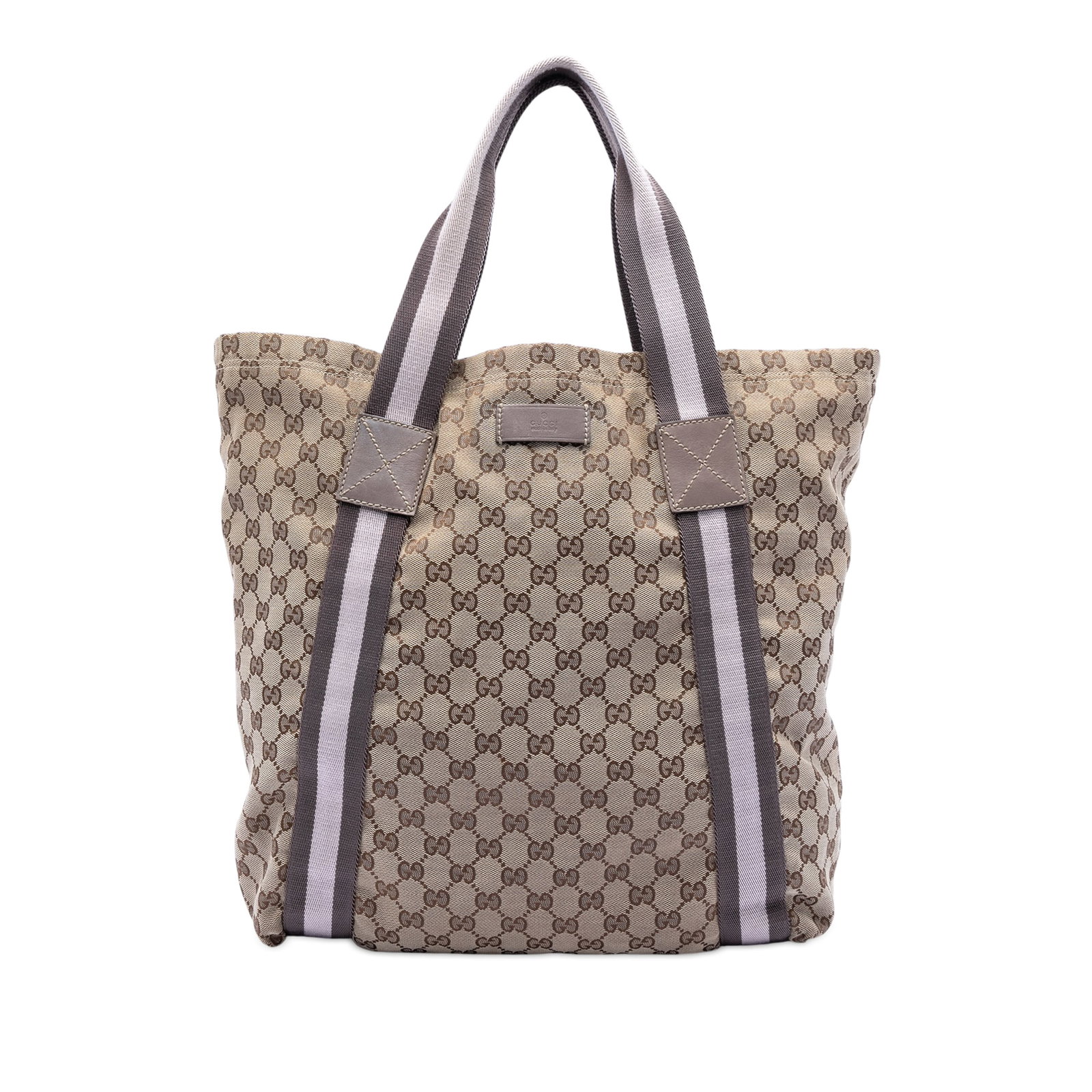 GG Canvas Web Tote Bag in Beige Fabric by Gucci: GG Canvas Web Tote Bag in Beige Fabric by Gucci This Gucci GG Canvas Web Tote features a beige canvas body with flat straps, an open top, and interior slip pockets. The bag shows signs of wear on the 
