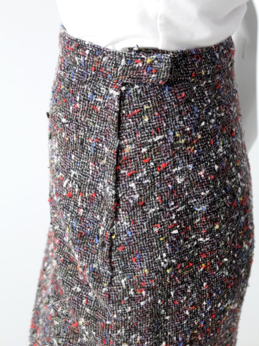 1950s Vintage Charcoal Tweed Pencil Skirt with Pleated Vent: 1950s Vintage Charcoal Tweed Pencil Skirt with Pleated Vent Step back in time with this stunning 1950s vintage tweed pencil skirt. Crafted from a soft charcoal marbled tweed, it features charming flec