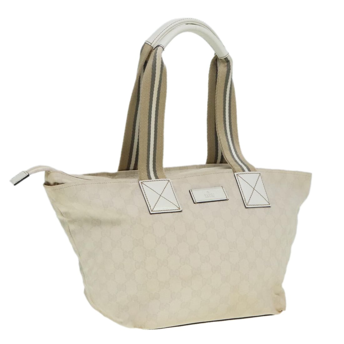 White GG Canvas Web Zip Tote Bag by Gucci: White GG Canvas Web Zip Tote Bag by Gucci This Gucci Web Zip Tote features a classic white GG canvas design with leather trim. Designed for unisex use, this tote offers a spacious interior and secure 