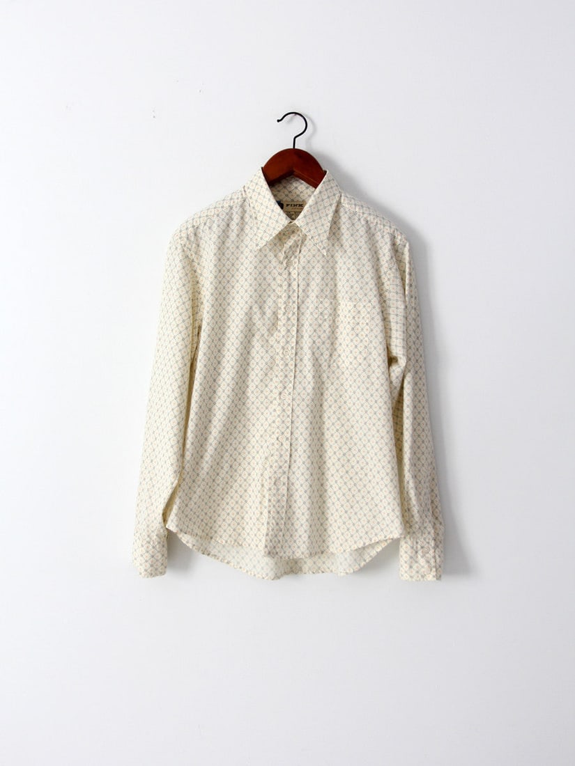 Vintage 70s Fink Clothing Cream Print Button Down Shirt: Vintage 70s Fink Clothing Cream Print Button Down Shirt This vintage men's button-down shirt hails from the late 1970s, crafted by Fink Clothing. It showcases a cream base adorned with a striking gold