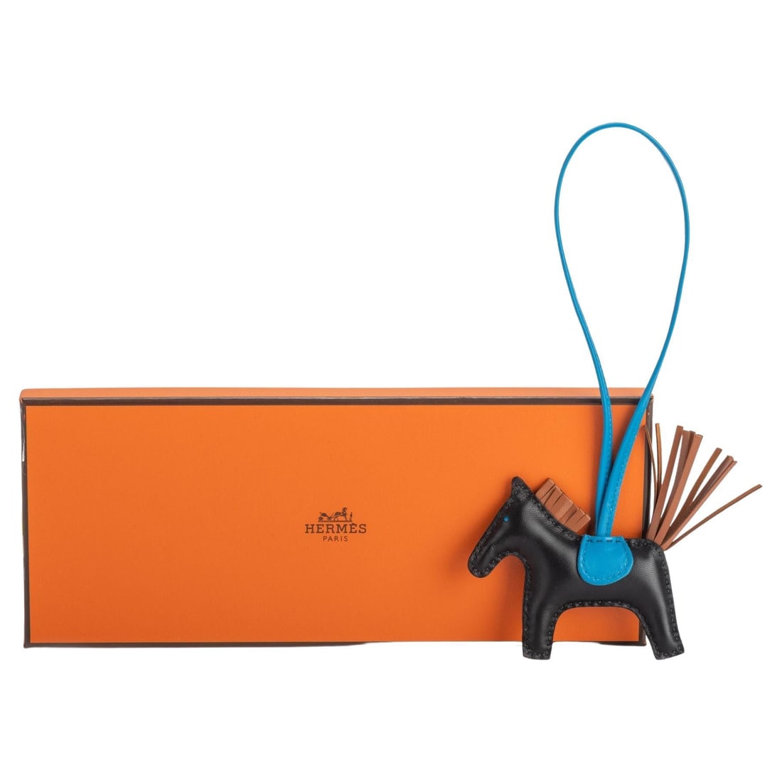 Hermes Grigri Rodeo PM Black Bag Charm with Box and Ribbon: Hermes Grigri Rodeo PM Black Bag Charm with Box and Ribbon Elevate your accessory collection with the Hermes Grigri Rodeo PM Black Bag Charm. This exquisite bag charm showcases a harmonious blend of b