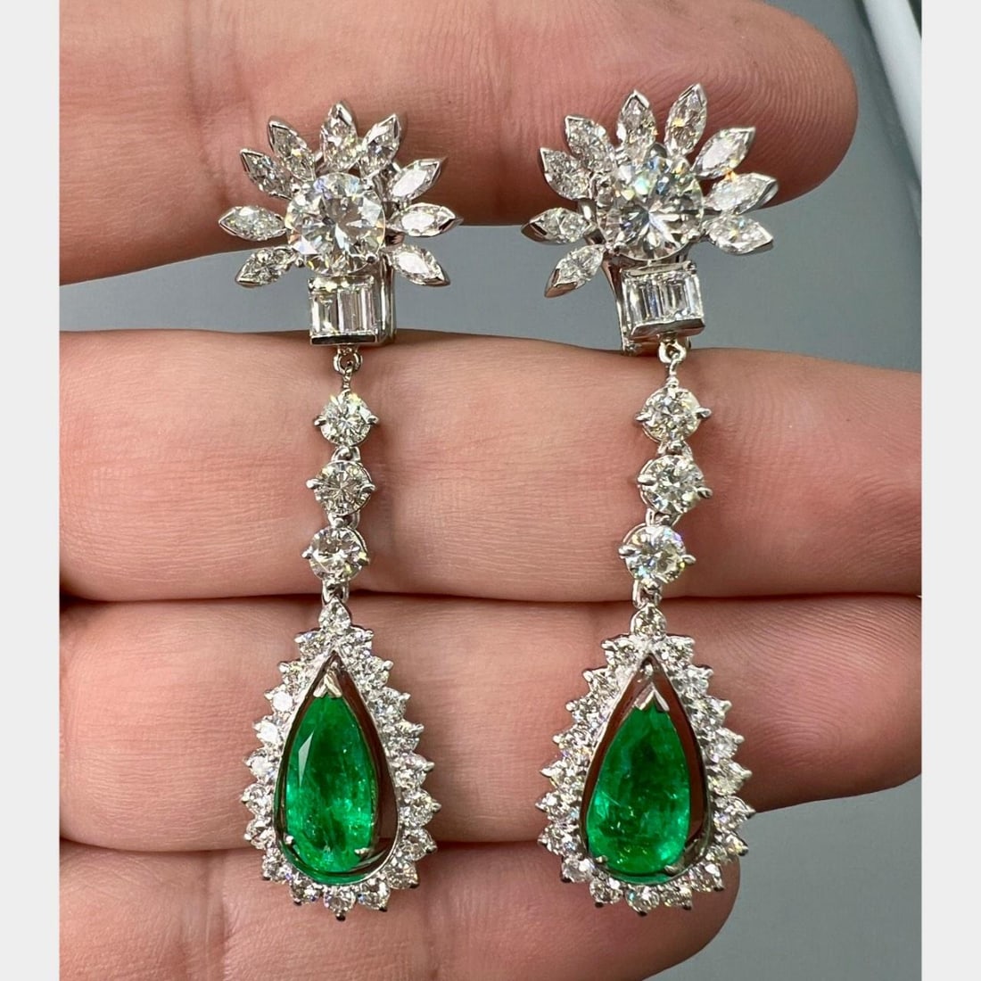 Platinum Earrings with Emeralds and Diamonds Circa 1950s 2 Inch Length: Platinum Earrings with Emeralds and Diamonds Circa 1950s 2 Inch Length Elegant emerald and diamond earrings crafted in platinum from the 1950s. Each earring features two emeralds with an approximate t