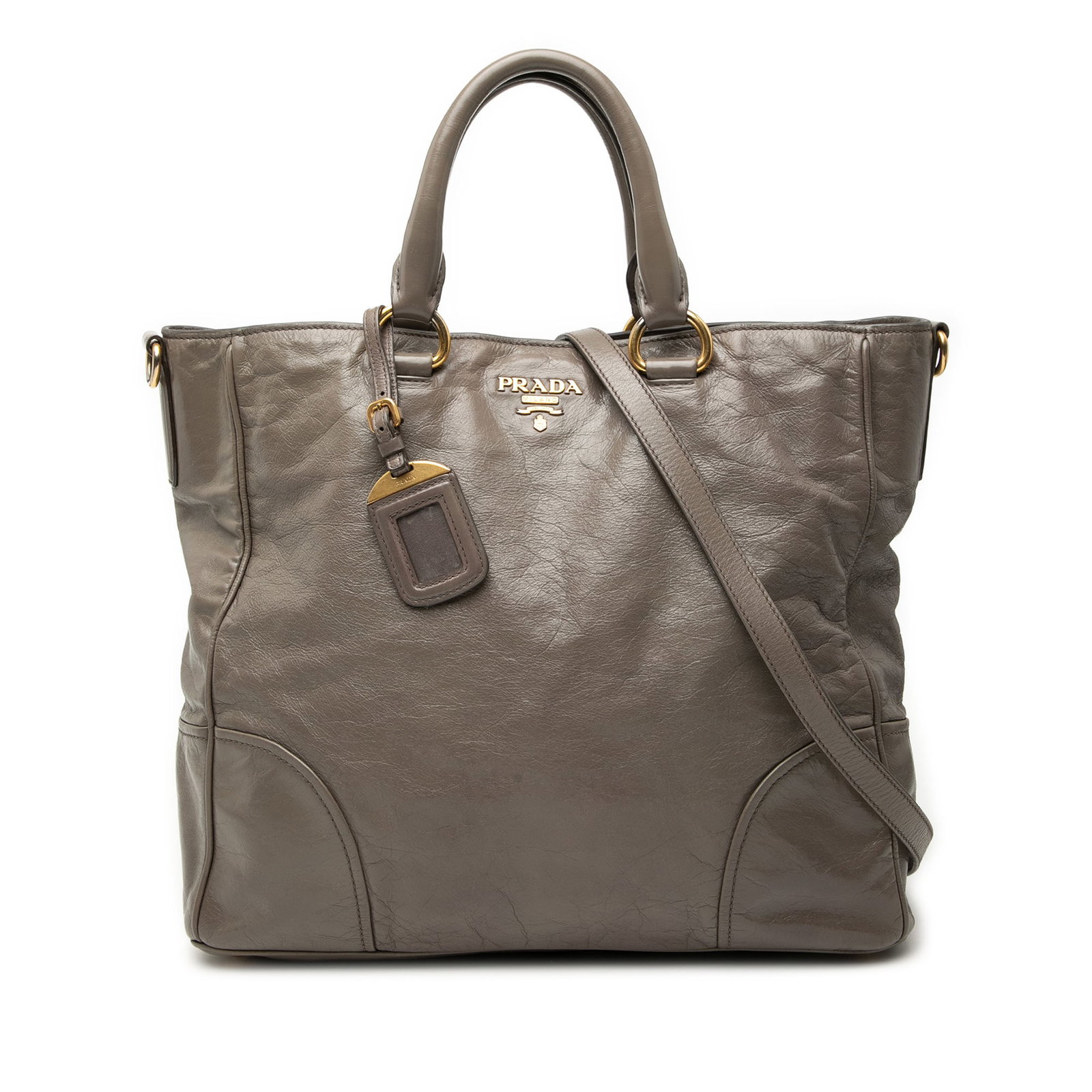 Brown Leather Satchel by Prada Vitello Shine with Detachable Strap: Brown Leather Satchel by Prada Vitello Shine with Detachable Strap This satchel features a leather body with rolled leather handles and a detachable flat leather strap. It has an open top with a magne
