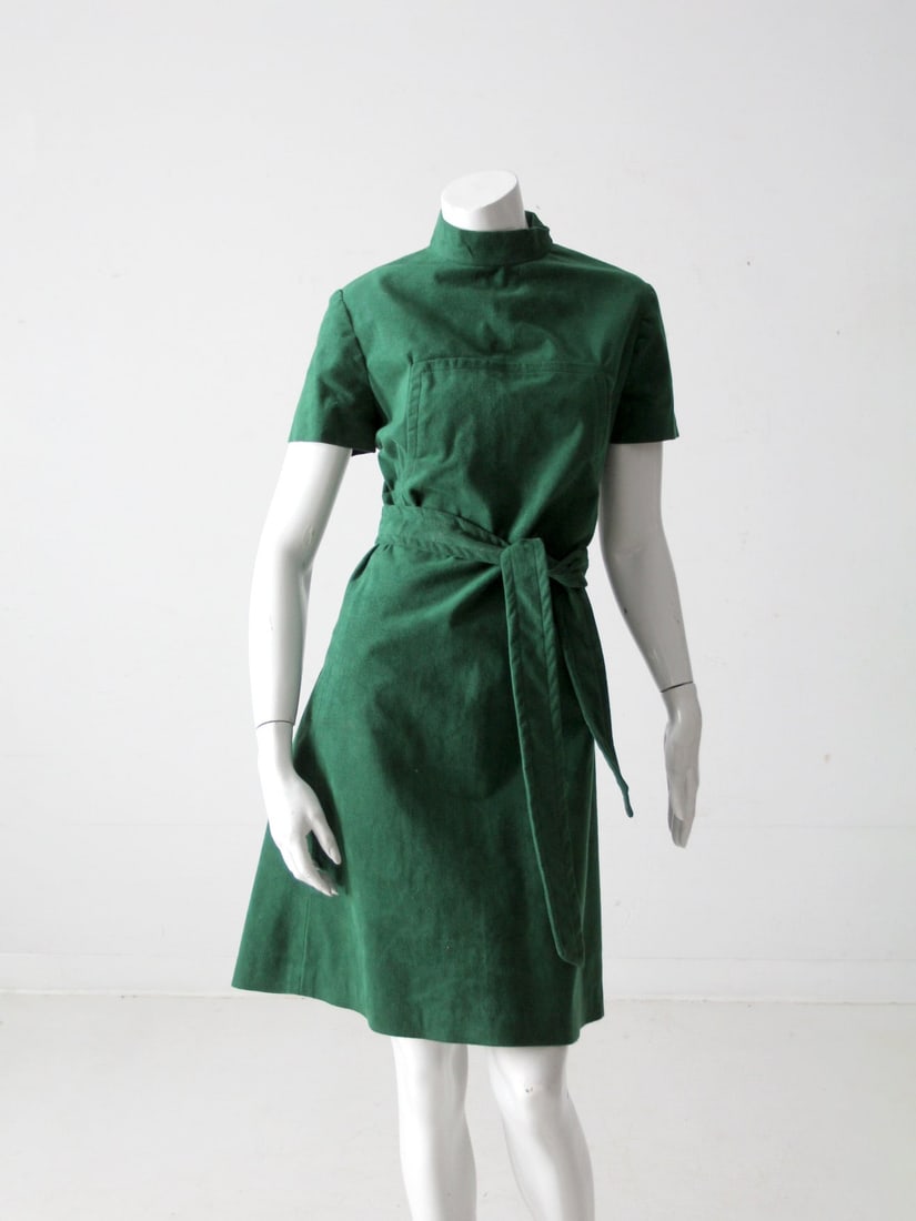 1970s Vintage Green Faux Suede A-Line Dress with Waist Tie: 1970s Vintage Green Faux Suede A-Line Dress with Waist Tie Step into a world of elegance with this stunning 1970s vintage green suede dress. Featuring a rich green hue and crafted from soft faux suede