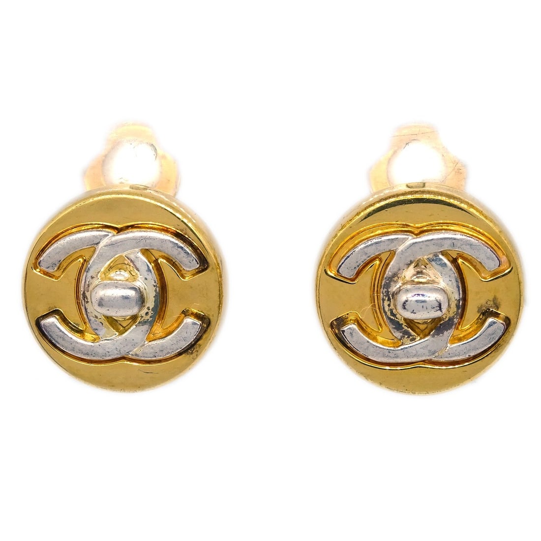 Chanel 97A Gold-Plated Turnlock Button Clip-On Earrings: Chanel 97A Gold-Plated Turnlock Button Clip-On Earrings These exquisite Chanel Turnlock Button Earrings feature a classic round design and are crafted from high-quality gold-plated material. The earri