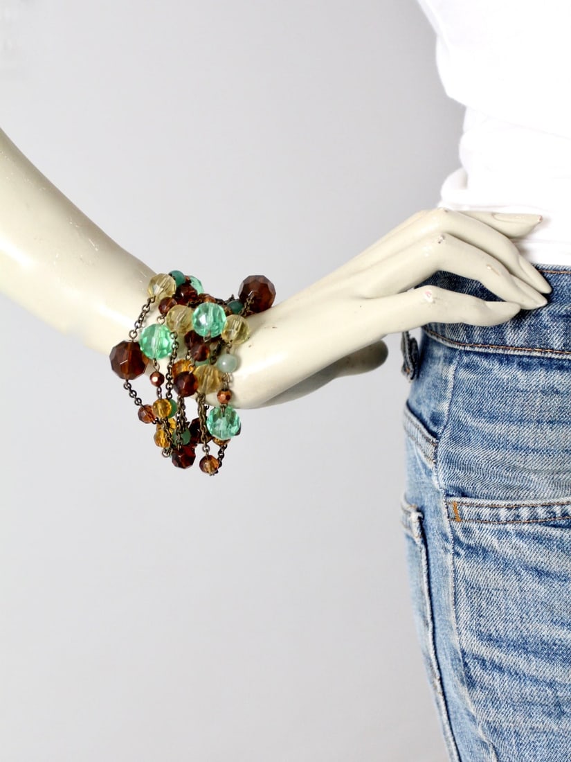 Vintage Multi-Chain Bracelet with Green Amber Gold Beads: Vintage Multi-Chain Bracelet with Green Amber Gold Beads Discover a stunning vintage faceted bead multi-chain bracelet, featuring an exquisite array of green, amber, and gold faceted and spherical bea