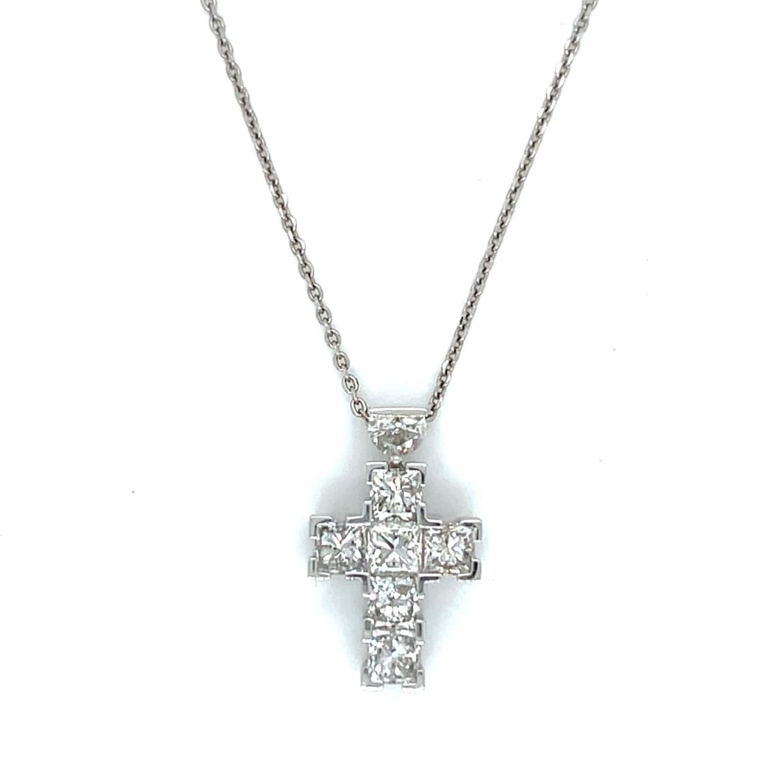 Diamond Cross Pendant 2.05 Ct in 18K White Gold with 14K Chain: Diamond Cross Pendant 2.05 Ct in 18K White Gold with 14K Chain This elegant pendant features a cross crafted from 18K white gold, adorned with seven diamonds totaling 2.05 carats. The diamonds are F-H