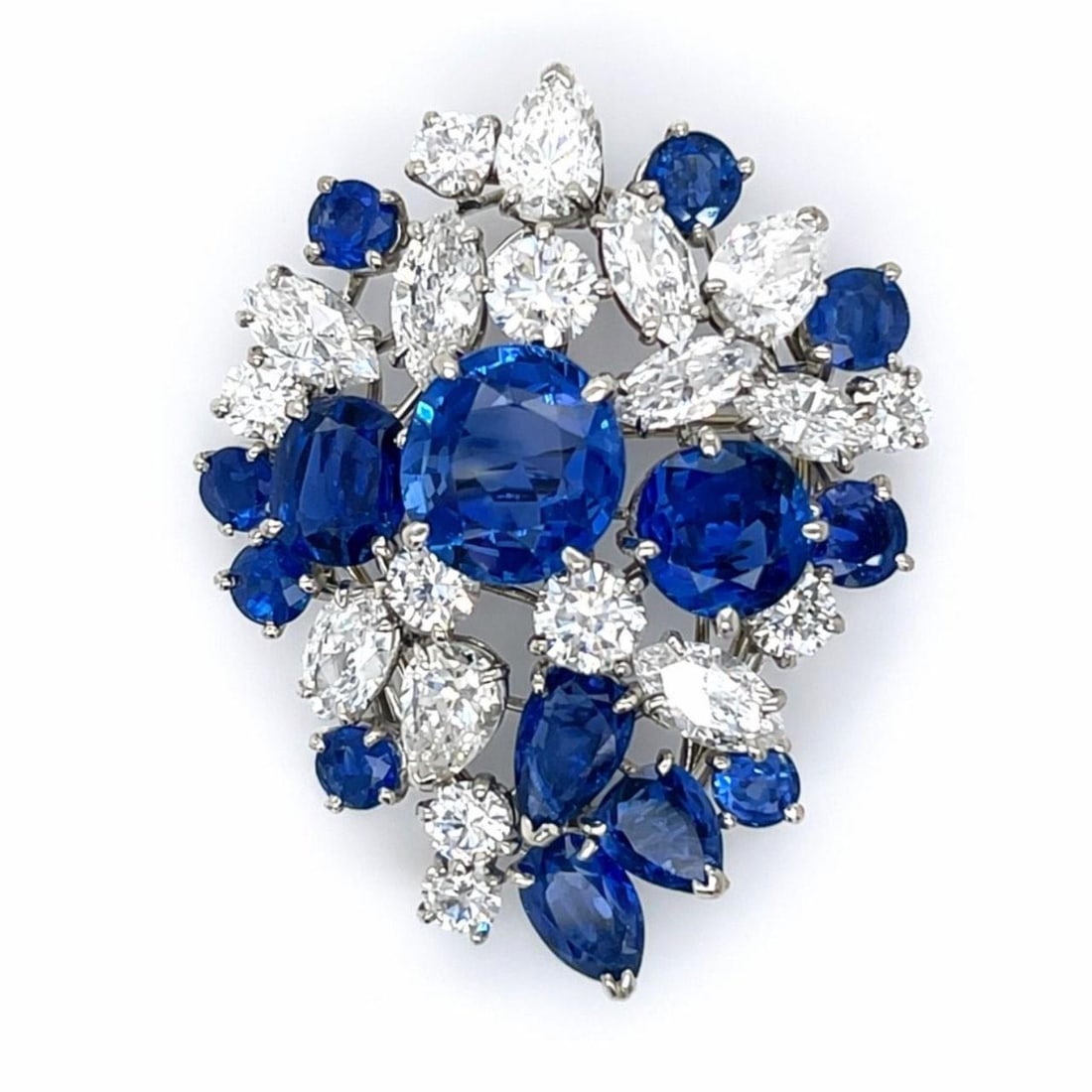 Platinum Brooch with Sapphires and Diamonds by Oscar Heyman Circa 1960s: Platinum Brooch with Sapphires and Diamonds by Oscar Heyman Circa 1960s This Oscar Heyman brooch from the 1960s is expertly crafted in platinum and showcases 14 sapphires totaling 14.08 carats and 19 