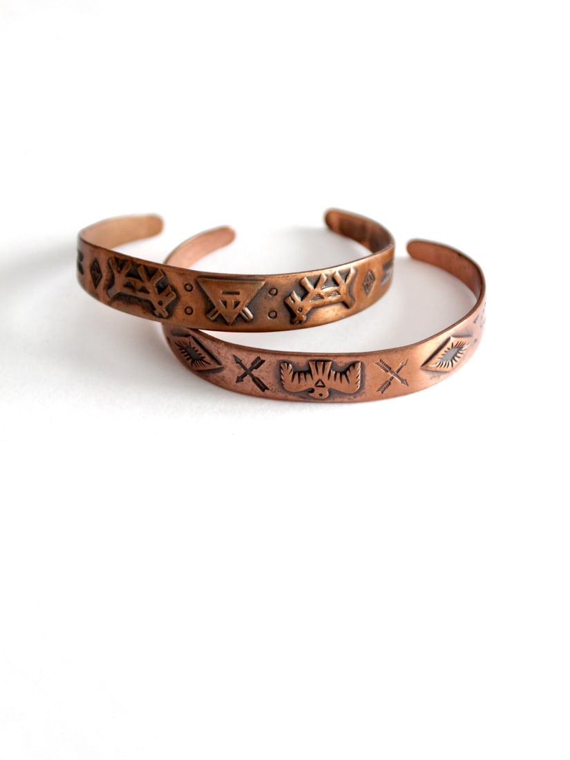 Southwestern Vintage Copper Cuff Bracelets Set of 2: Southwestern Vintage Copper Cuff Bracelets Set of 2 Enhance your jewelry collection with this beautiful set of two vintage Southwestern copper cuff bracelets, ideal for stacking. Each cuff showcases i