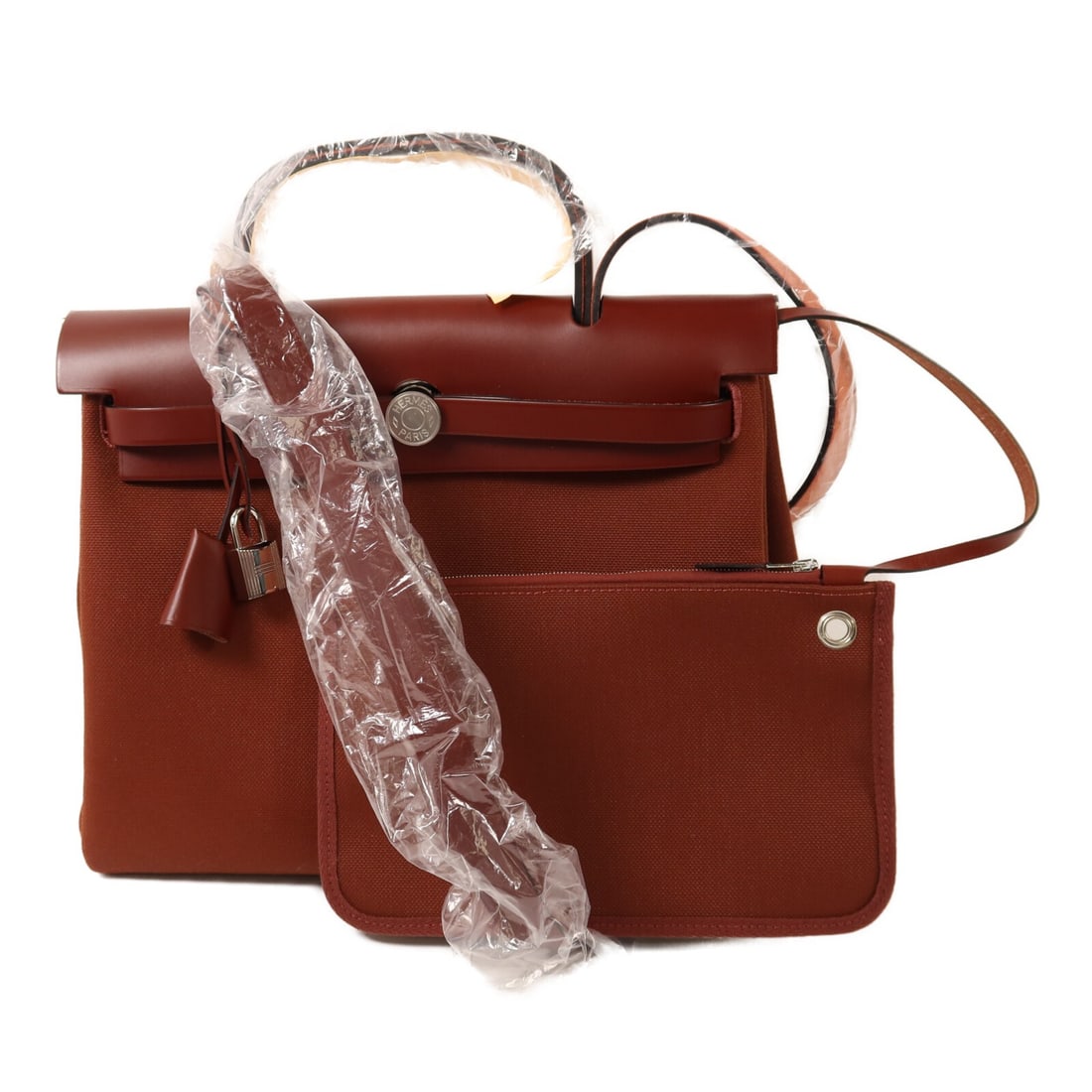 Herbag PM Canvas Shoulder Bag Red by Hermes with Palladium Hardware: Herbag PM Canvas Shoulder Bag Red by Hermes with Palladium Hardware This Hermes Herbag PM is a versatile 2-way shoulder bag crafted from red canvas, featuring a pristine condition. Made in France, it 