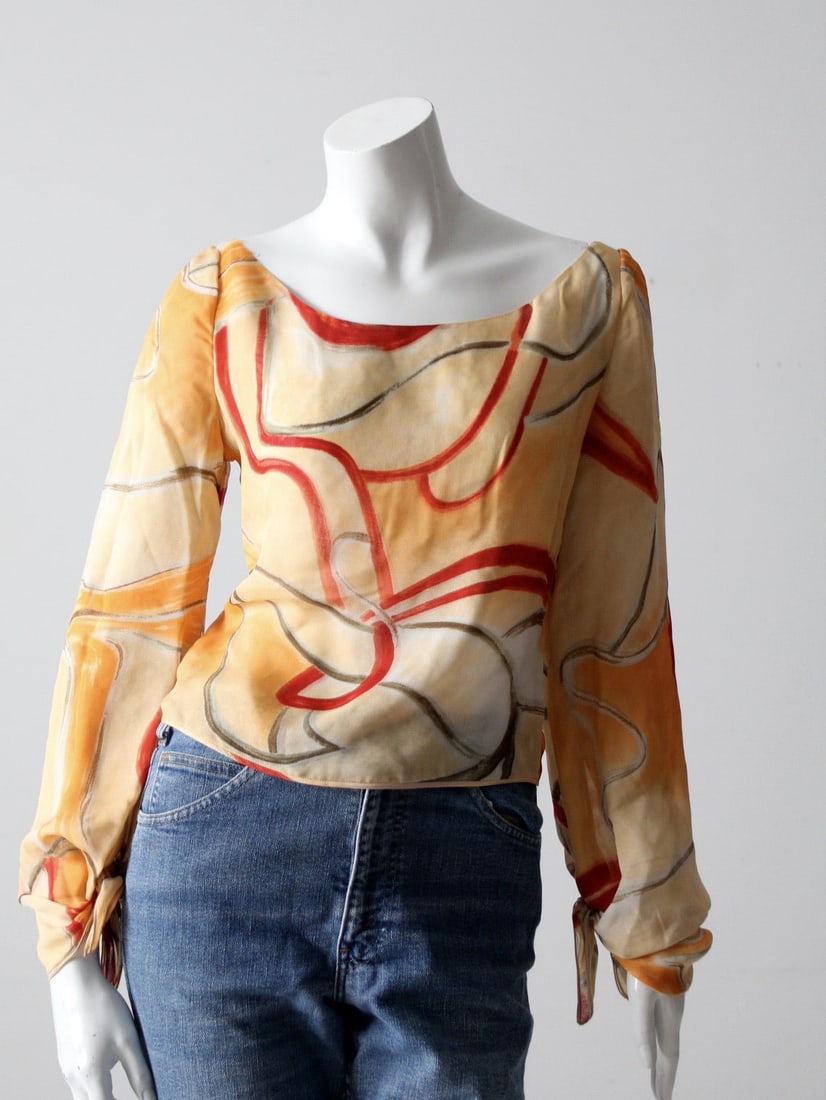 Vintage Valentino Sheer Blouse with Vibrant Swirl Print: Vintage Valentino Sheer Blouse with Vibrant Swirl Print Explore this stunning vintage Valentino blouse, featuring a vibrant swirl print in orange, goldenrod, red, and brown hues. This sheer top showca