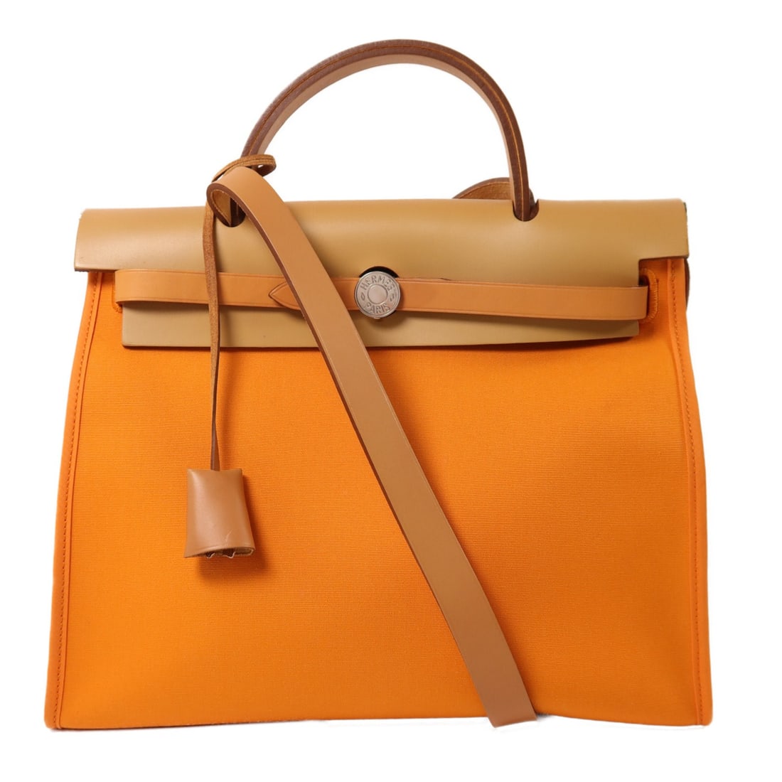 Herbag PM Orange Canvas Shoulder Bag with Palladium Hardware by Hermes: Herbag PM Orange Canvas Shoulder Bag with Palladium Hardware by Hermes This Hermes Herbag PM is a two-way shoulder bag crafted from orange canvas. Designed for women, it features an adjustable strap f