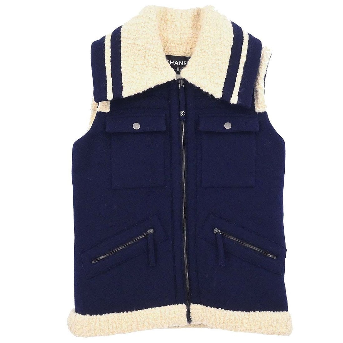 Chanel Navy Sleeveless Wool Angora Jacket Size 38: Chanel Navy Sleeveless Wool Angora Jacket Size 38 This Chanel sleeveless jacket vest features a zip-up front and a mid-length silhouette, crafted from a luxurious blend of 80% wool and 20% angora. The
