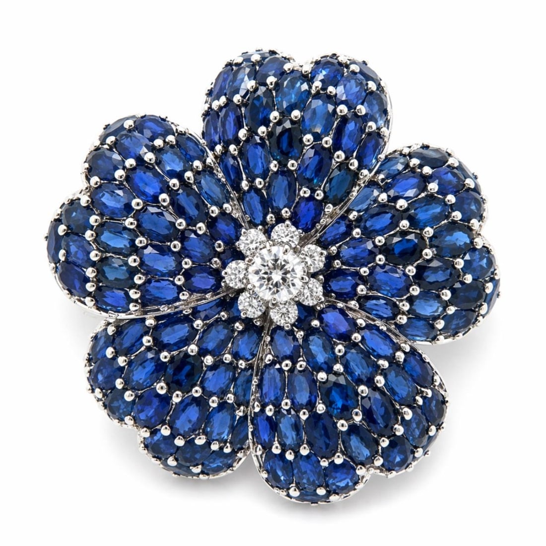 Floral Brooch in 18K White Gold with Sapphires and Diamonds 2 Inch: Floral Brooch in 18K White Gold with Sapphires and Diamonds 2 Inch This brooch is crafted in 18K white gold and features a delicate flower design. It is set with 8 diamonds totaling approximately 1.20