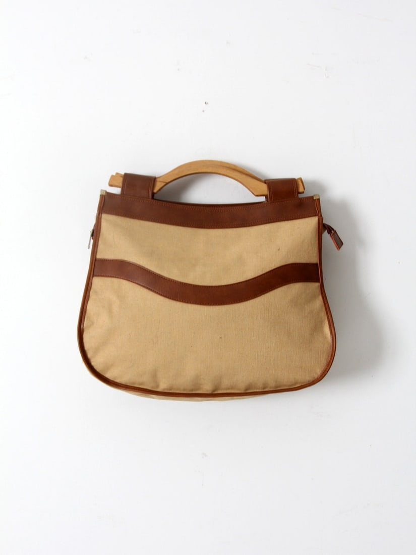 Vintage Ultima II Charles Revson Tote Bag with Wood Handles: Vintage Ultima II Charles Revson Tote Bag with Wood Handles This vintage Ultima II Charles Revson tote bag is an eye-catching accessory perfect for travel or everyday use. Constructed from durable fau