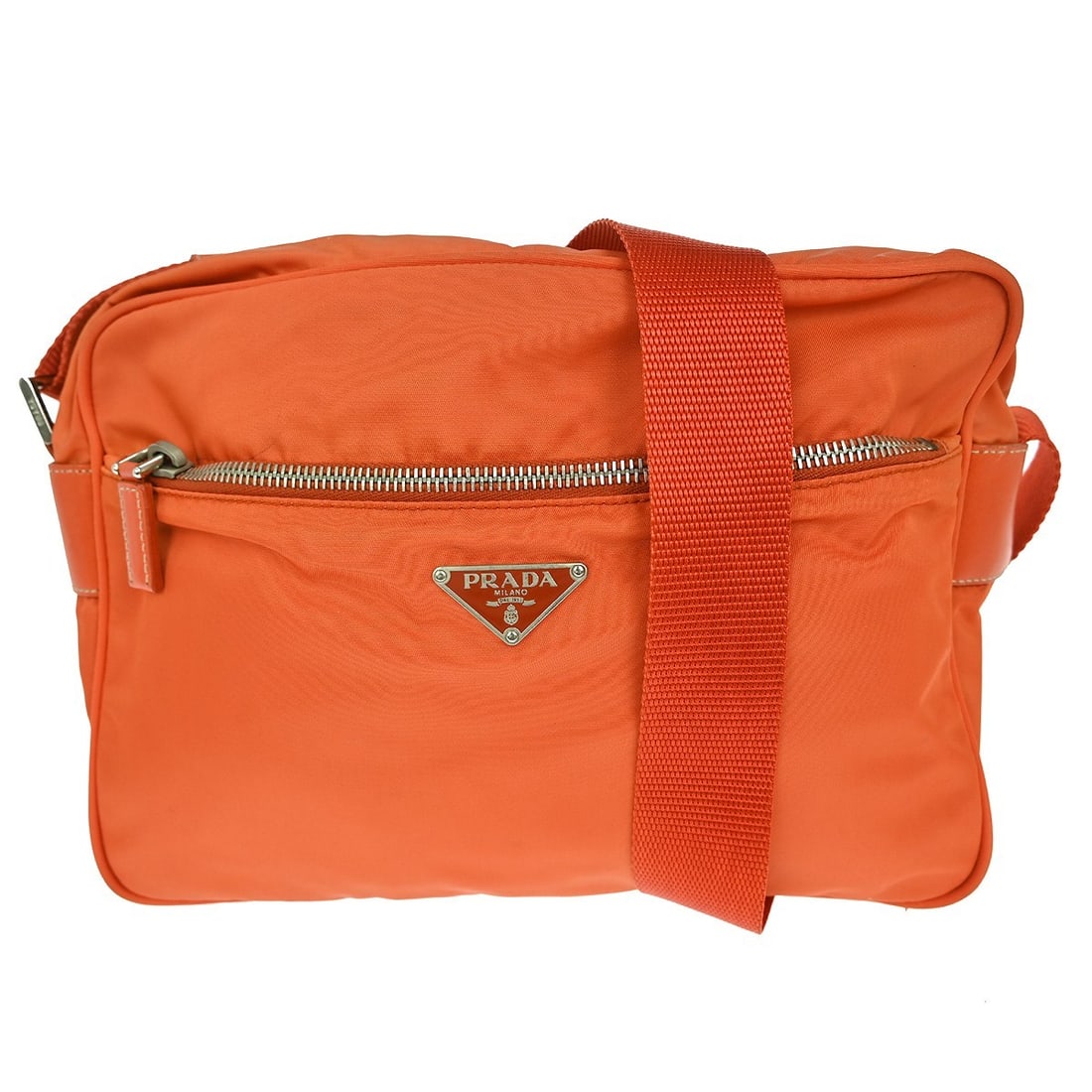 Prada Nylon Orange Crossbody Bag Medium Buckle Logo: Prada Nylon Orange Crossbody Bag Medium Buckle Logo This Prada orange nylon crossbody bag features a medium-sized silhouette with a secure buckle closure. The bag is crafted from durable nylon, both i