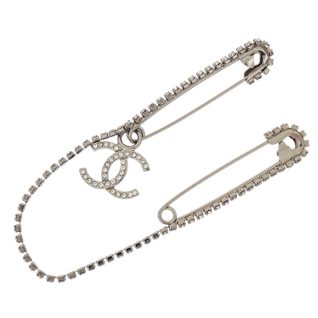 Silver Plated Chanel CC Dangle Brooch with Rhinestones: Silver Plated Chanel CC Dangle Brooch with Rhinestones This Chanel dangle CC brooch features a silver plated finish and sparkling rhinestones, showcasing the iconic CC logo. Crafted in France, it offe