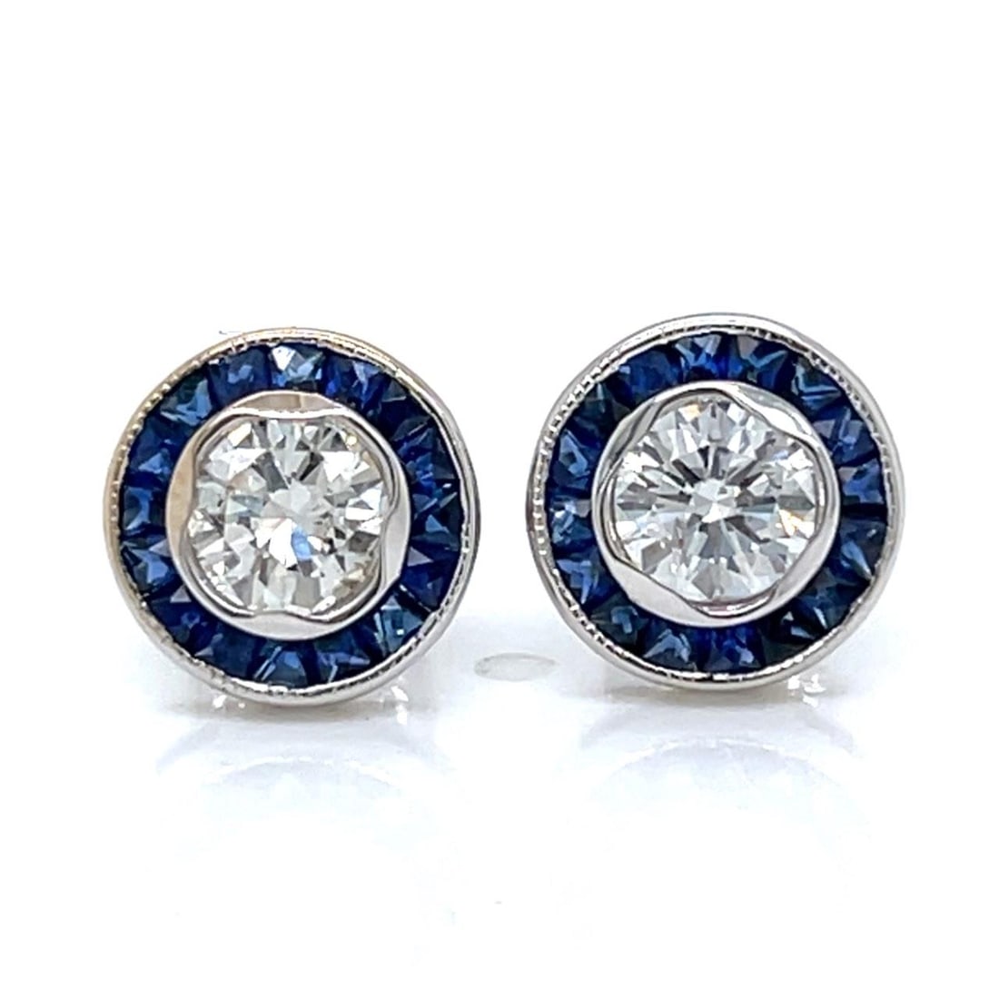 Diamond and Sapphire Stud Earrings in 18K White Gold: Diamond and Sapphire Stud Earrings in 18K White Gold These stud earrings are crafted from 18K white gold and set with two diamonds totaling 0.83 carats, featuring F-G color and VS1-SI1 clarity. The ea