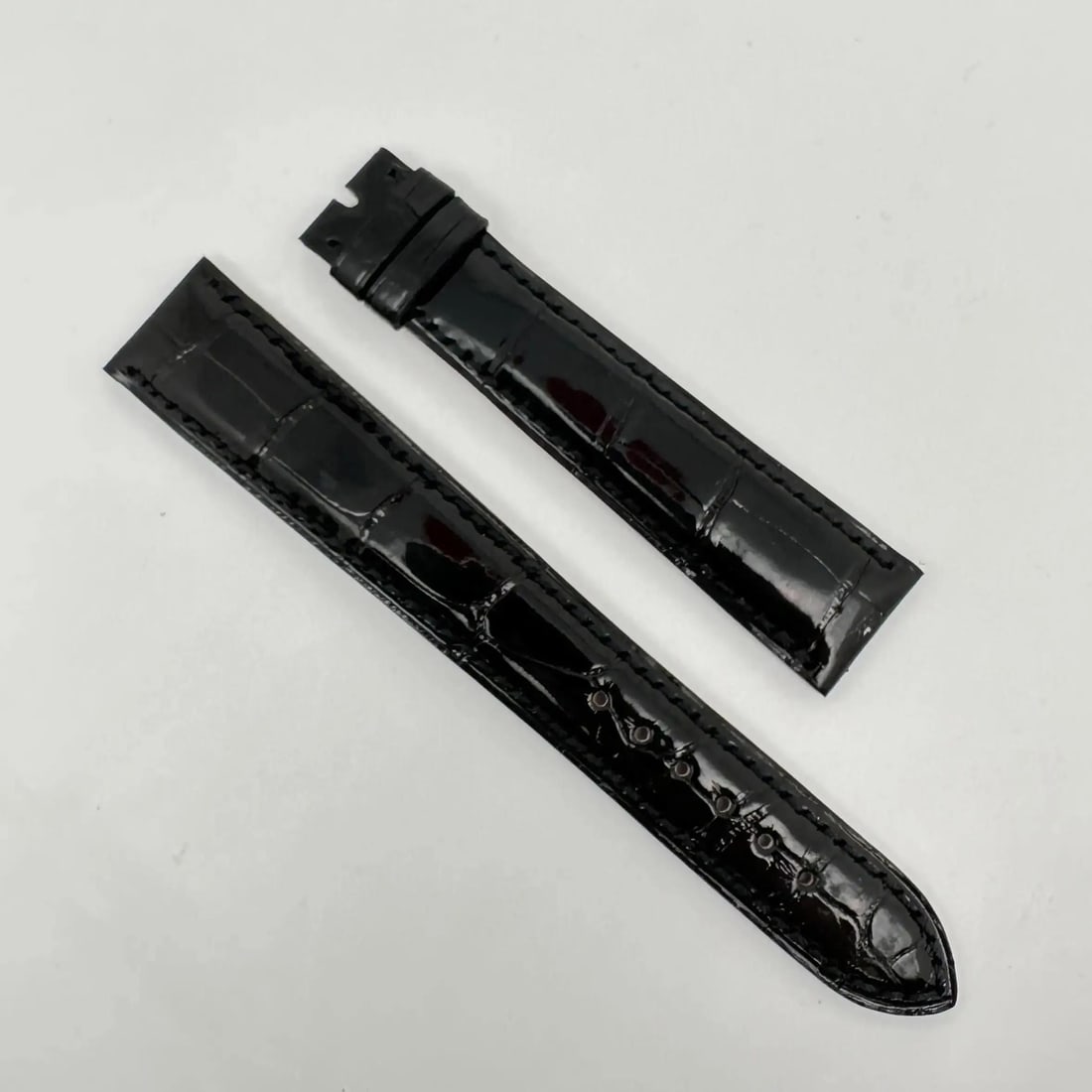 Bvlgari Black Alligator Leather Wristwatch Band 19mm x 16mm: Bvlgari Black Alligator Leather Wristwatch Band 19mm x 16mm Enhance your timepiece with this luxurious Bvlgari wristwatch band, crafted from high-quality black alligator leather. This two-piece strap 