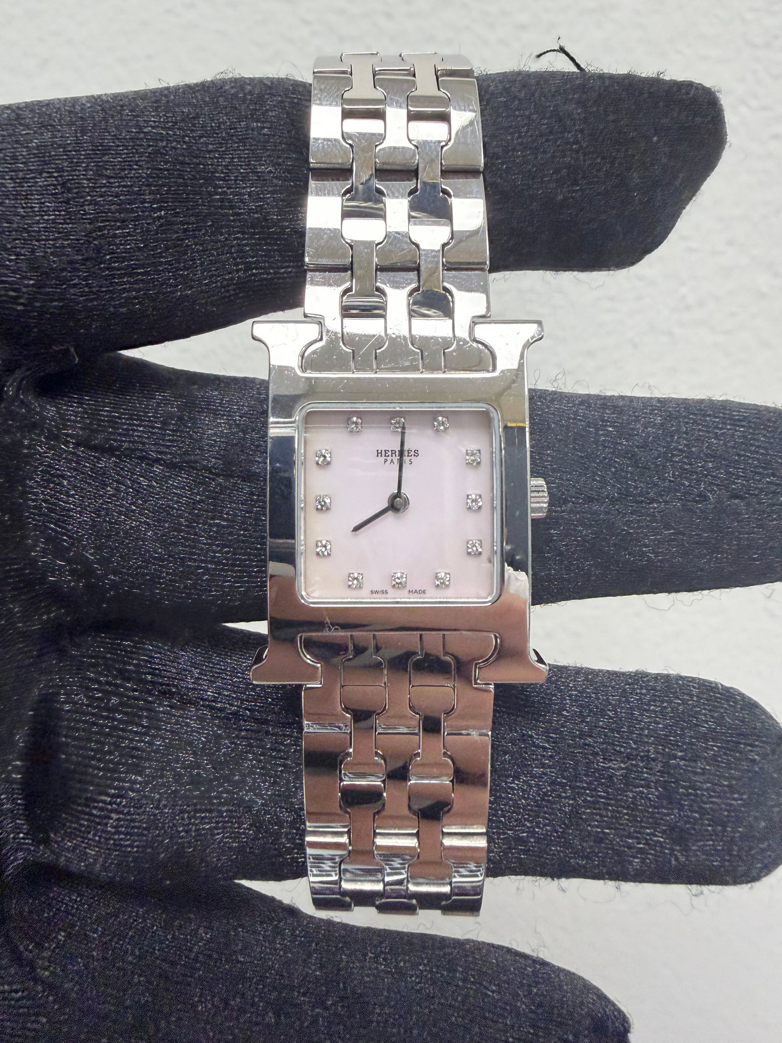 Heure H Stainless Steel Watch Pink Mother of Pearl Diamond Dial 21x30mm: Heure H Stainless Steel Watch Pink Mother of Pearl Diamond Dial 21x30mm This Hermes Heure H watch features a pink mother-of-pearl diamond dial, reference HH1.210. The timepiece is crafted in stainless