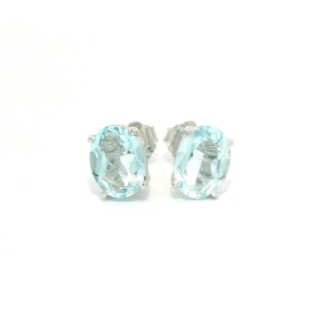 New 14k White Gold Oval Blue Aquamarine 1.98ctw Stud Earrings: New 14k White Gold Oval Blue Aquamarine 1.98ctw Stud Earrings These stunning stud earrings feature two natural genuine aquamarine stones, expertly cut into an oval shape and prong set for a secure fit