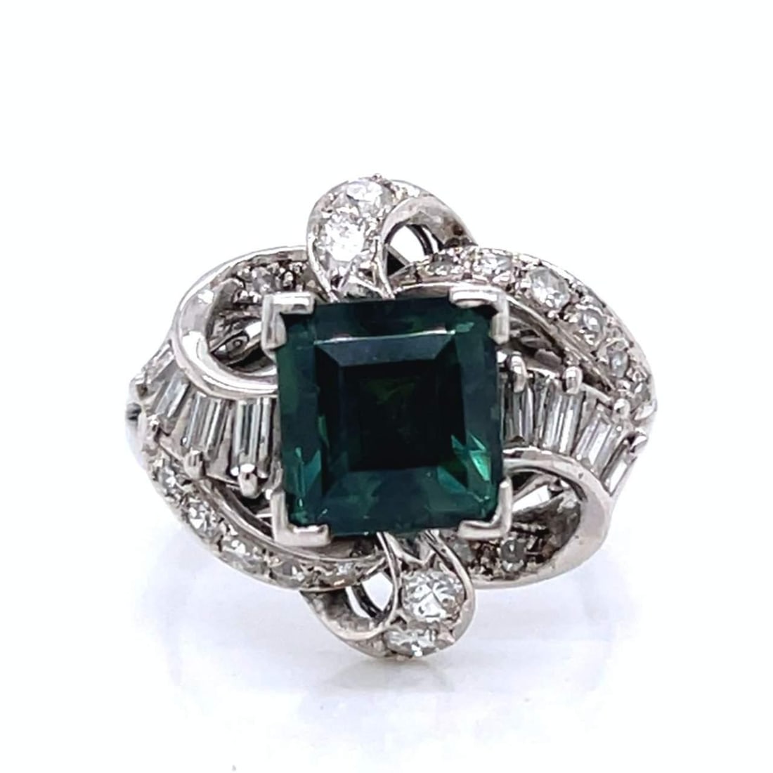 Vintage 1950's 18K White Gold NGI Certified Green Sapphire Diamond Ring: Vintage 1950's 18K White Gold NGI Certified Green Sapphire Diamond Ring This exquisite 1950's ring features an enchanting NGI Certified Green Sapphire, weighing approximately 2.70 Ct, beautifully set 