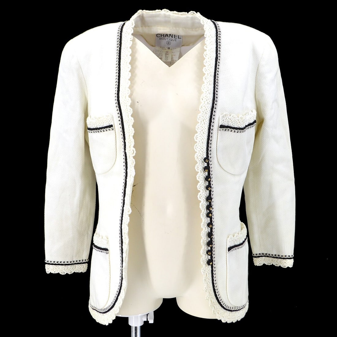 Chanel White Collarless Jacket 100% Cotton Silk Lined Size 36: Chanel White Collarless Jacket 100% Cotton Silk Lined Size 36 Elevate your wardrobe with this Chanel Collarless Jacket in a pristine white color. Crafted from 100% cotton, this mid-length jacket featu