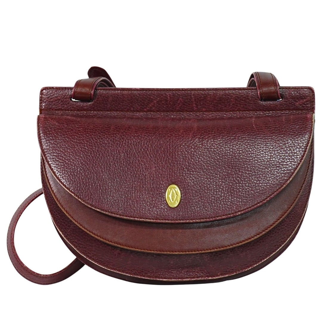 Must de Cartier burgundy leather shoulder bag for women: Must de Cartier burgundy leather shoulder bag for women This Must de Cartier shoulder bag is crafted from burgundy leather and designed for women. It features a sleek silhouette with dimensions of 26c