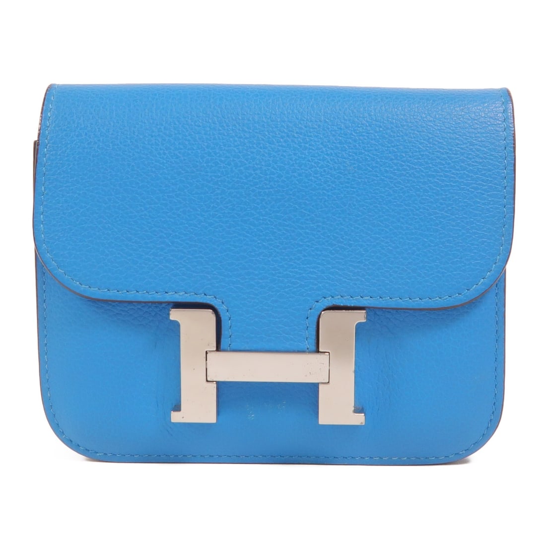 Hermes Constance Slim bi-fold wallet Bleu Zanzibar leather: Hermes Constance Slim bi-fold wallet Bleu Zanzibar leather This Hermes Constance Slim Wallet is crafted from Evercolor leather in a striking Bleu Zanzibar shade. Designed as a bi-fold wallet, it offer