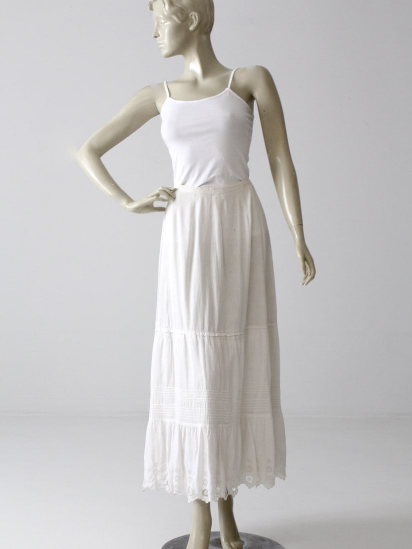 Antique Victorian Cotton Petticoat Skirt with Eyelet Pattern: Antique Victorian Cotton Petticoat Skirt with Eyelet Pattern Discover a charming piece from the late Victorian era with this exquisite antique petticoat skirt. Crafted from white cotton, this skirt sh