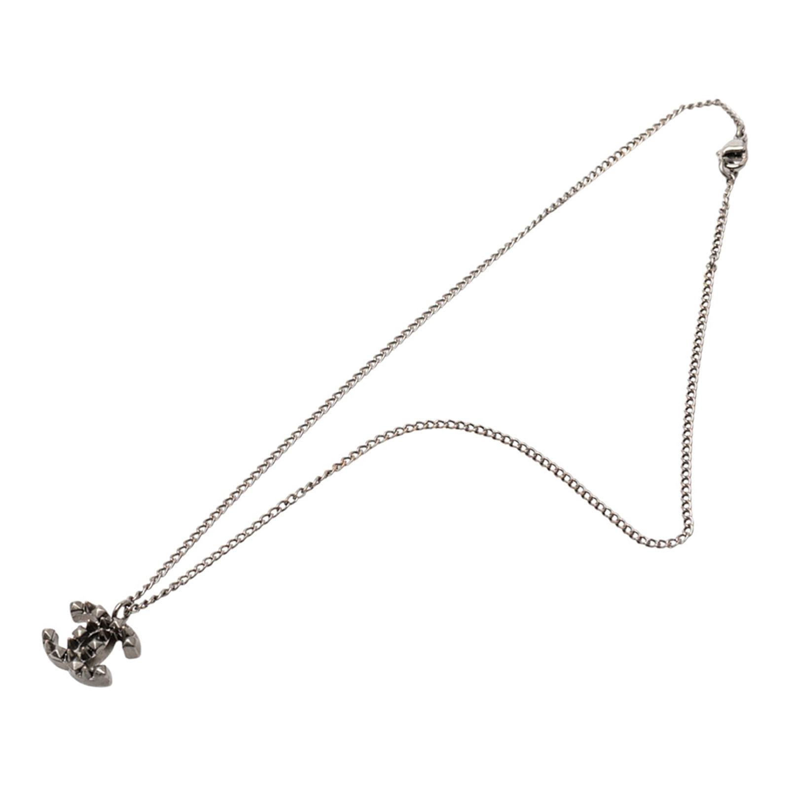 Chanel Spiked CC Pendant Necklace in Ruthenium Plated Metal: Chanel Spiked CC Pendant Necklace in Ruthenium Plated Metal This Chanel necklace features a ruthenium-plated metal body with a striking spiked CC pendant and a lobster clasp closure. The piece is desi