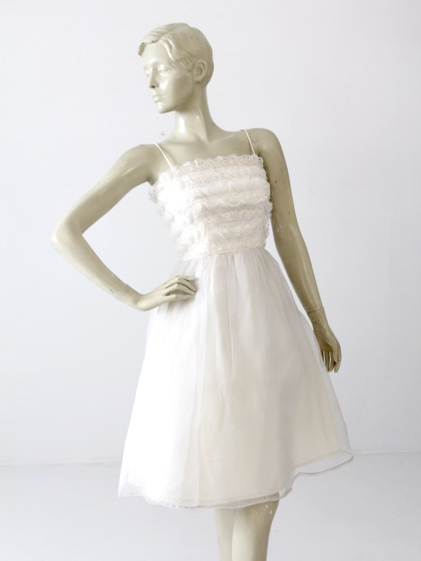 1960s Vintage Saks Fifth Avenue White Lace Party Dress: 1960s Vintage Saks Fifth Avenue White Lace Party Dress Step back in time with this exquisite 1960s vintage Saks Fifth Avenue party dress. This charming little white dress showcases delicate white lace