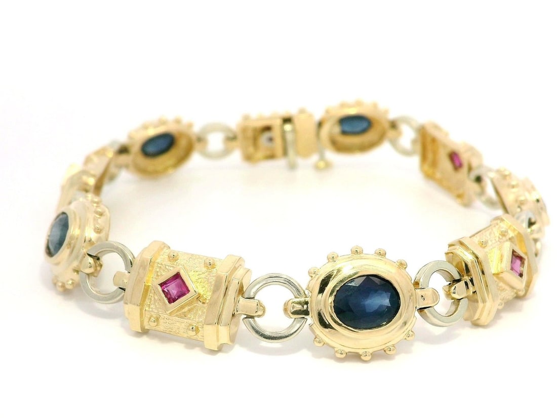 14k Yellow Gold Geometric Bracelet with 5ctw Oval Sapphire and Ruby: 14k Yellow Gold Geometric Bracelet with 5ctw Oval Sapphire and Ruby This exquisite bracelet features a stunning combination of five natural oval sapphires and five square rubies, all set in solid 14k 
