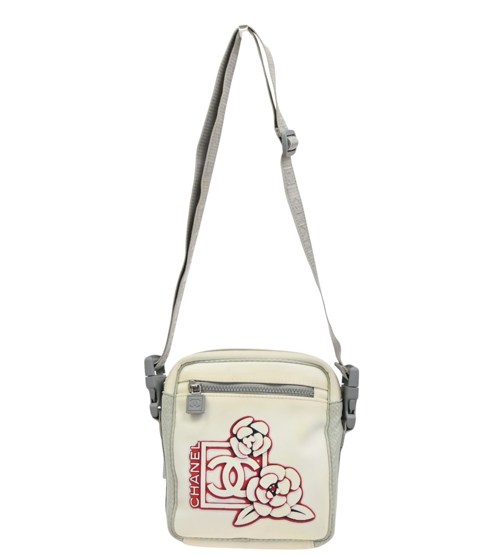 Chanel Travel Line White Nylon Crossbody Purse 17cm x 20cm: Chanel Travel Line White Nylon Crossbody Purse 17cm x 20cm This Chanel Travel Line crossbody bag is crafted from white nylon and designed for women. It features a compact silhouette and is made in Ita