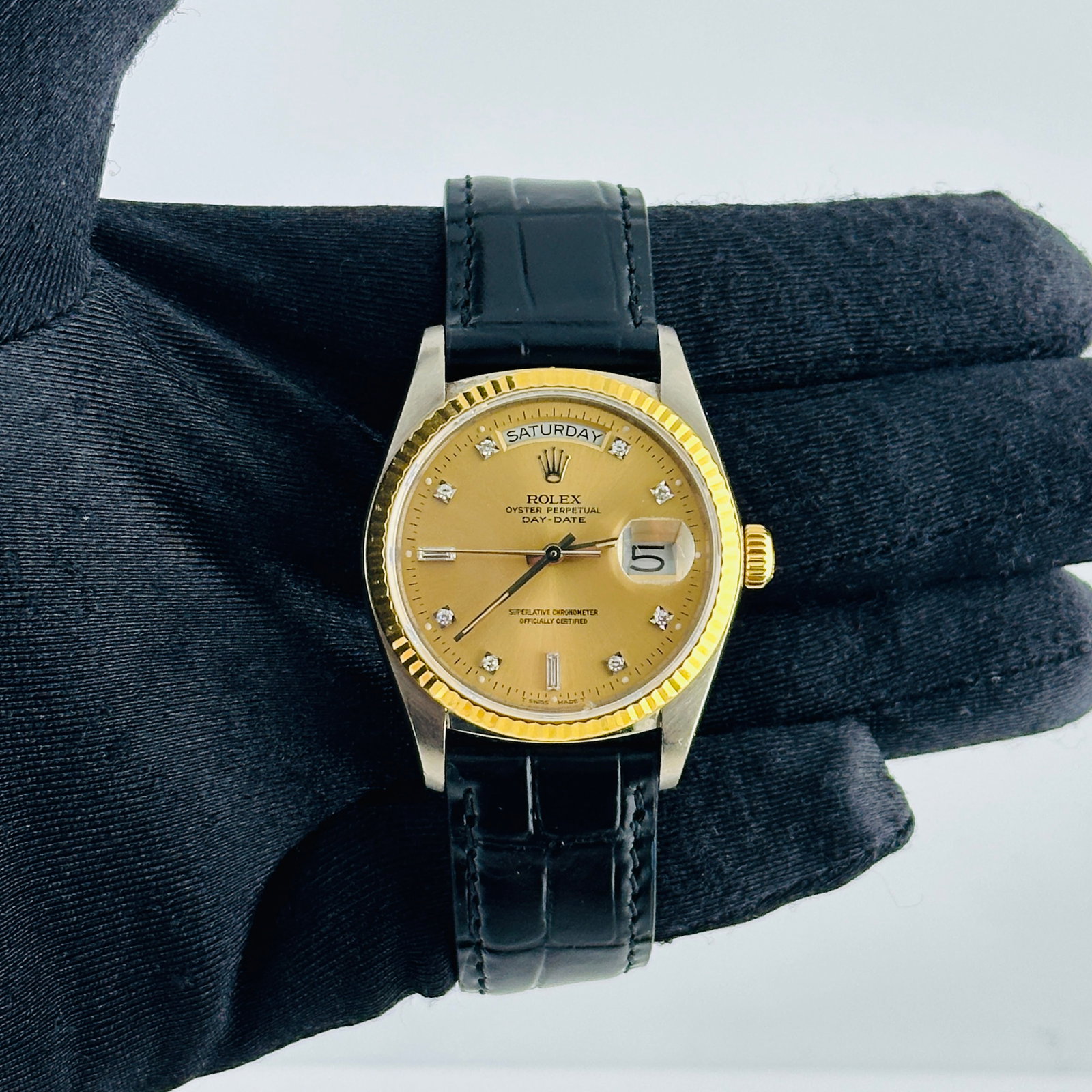 Day Date Tridor Ref 18039B Champagne Diamond Dial Watch on Leather Strap: Day Date Tridor Ref 18039B Champagne Diamond Dial Watch on Leather Strap The Rolex Day Date Tridor features a champagne diamond factory dial and a fluted bezel, complemented by an aftermarket leather 