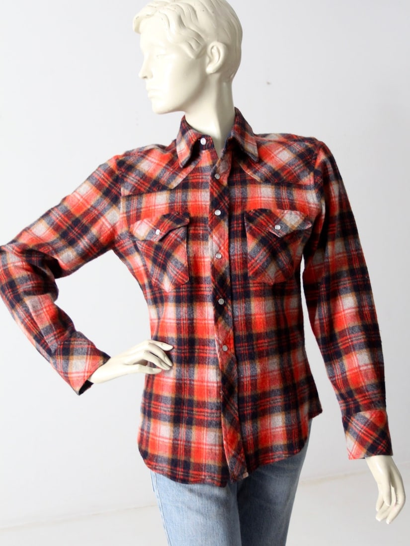 1970s Vintage Queen's Way Western Snap-Up Shirt Plaid: 1970s Vintage Queen's Way Western Snap-Up Shirt Plaid Step back in time with this authentic 1970s vintage western snap-up shirt. Crafted from a soft wool blend, this shirt showcases a striking red, bl