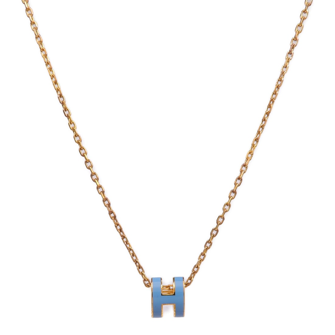 Mini Pop H gold tone necklace by Hermes in blue: Mini Pop H gold tone necklace by Hermes in blue This HERMES Mini Pop H necklace features a sleek gold-tone finish with a blue accent. Crafted in France, it is designed without any gemstones, offering 