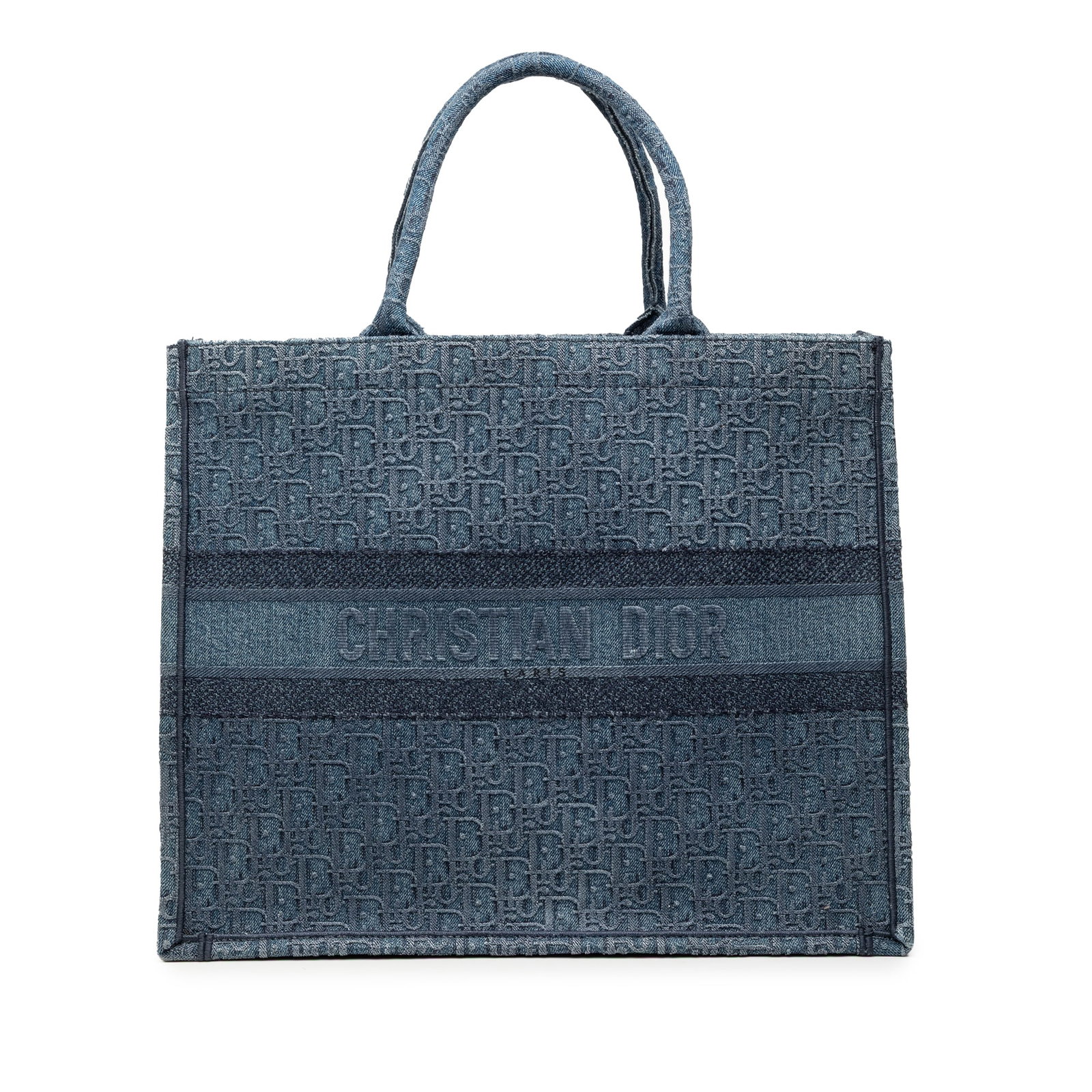 Dior Blue Denim Book Tote in Large Oblique Pattern: Dior Blue Denim Book Tote in Large Oblique Pattern This Dior Large Oblique Denim Book Tote features a blue denim fabric body with rolled top handles and an open top design. The tote is crafted in Ital