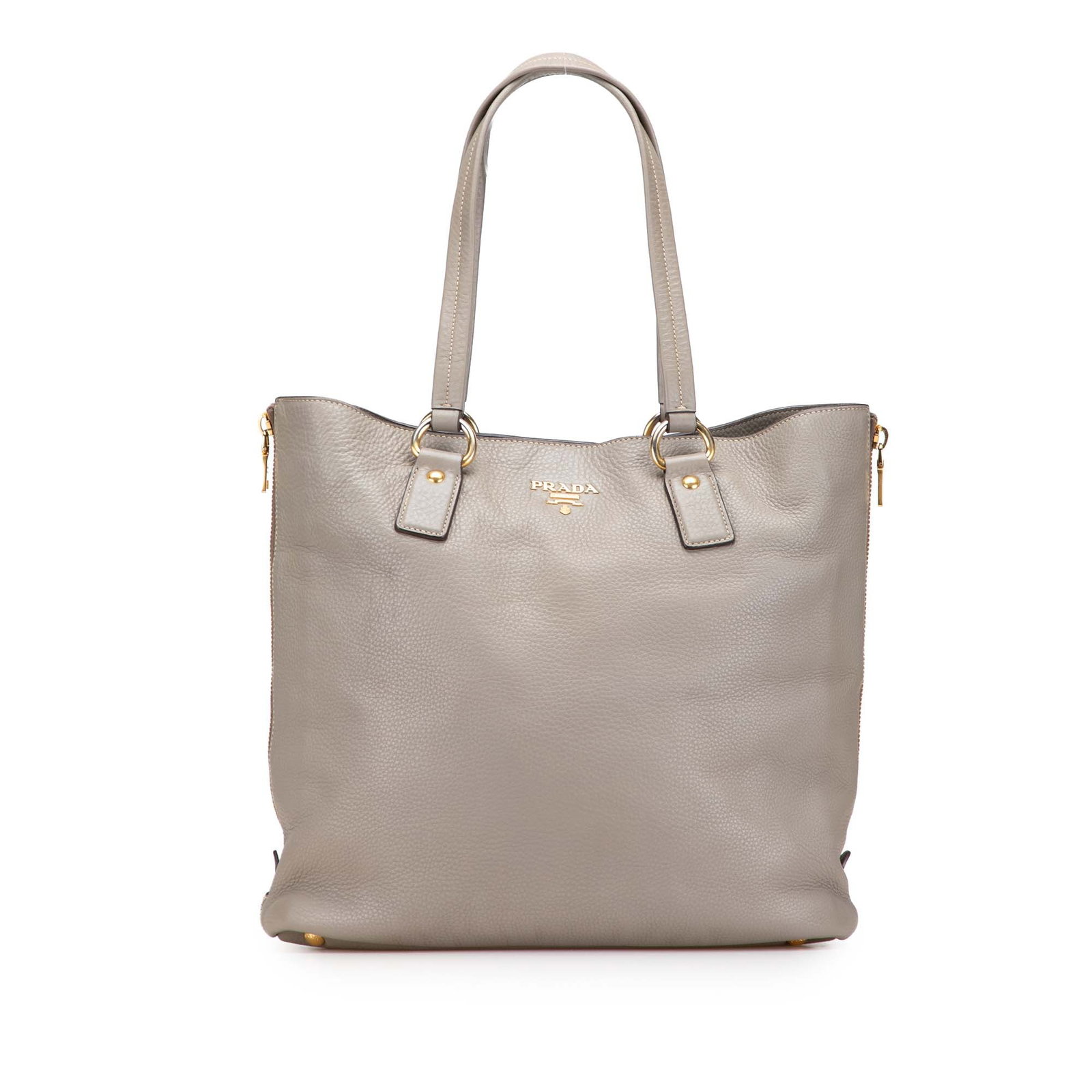 Prada Vitello Daino Gray Leather Side Zip Tote Bag: Prada Vitello Daino Gray Leather Side Zip Tote Bag This Prada Vitello Daino Side Zip Shopper Tote is a stylish and functional accessory crafted from high-quality leather. The tote features zip expansi