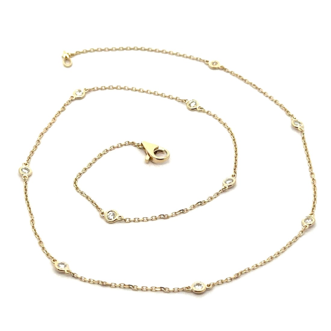 14k Yellow Gold 0.64ctw Diamond By The Yard Necklace 18 Inches: 14k Yellow Gold 0.64ctw Diamond By The Yard Necklace 18 Inches This exquisite 14k Yellow Gold By The Yard Necklace features 10 stunning round brilliant cut diamonds, each bezel set for a sophisticated