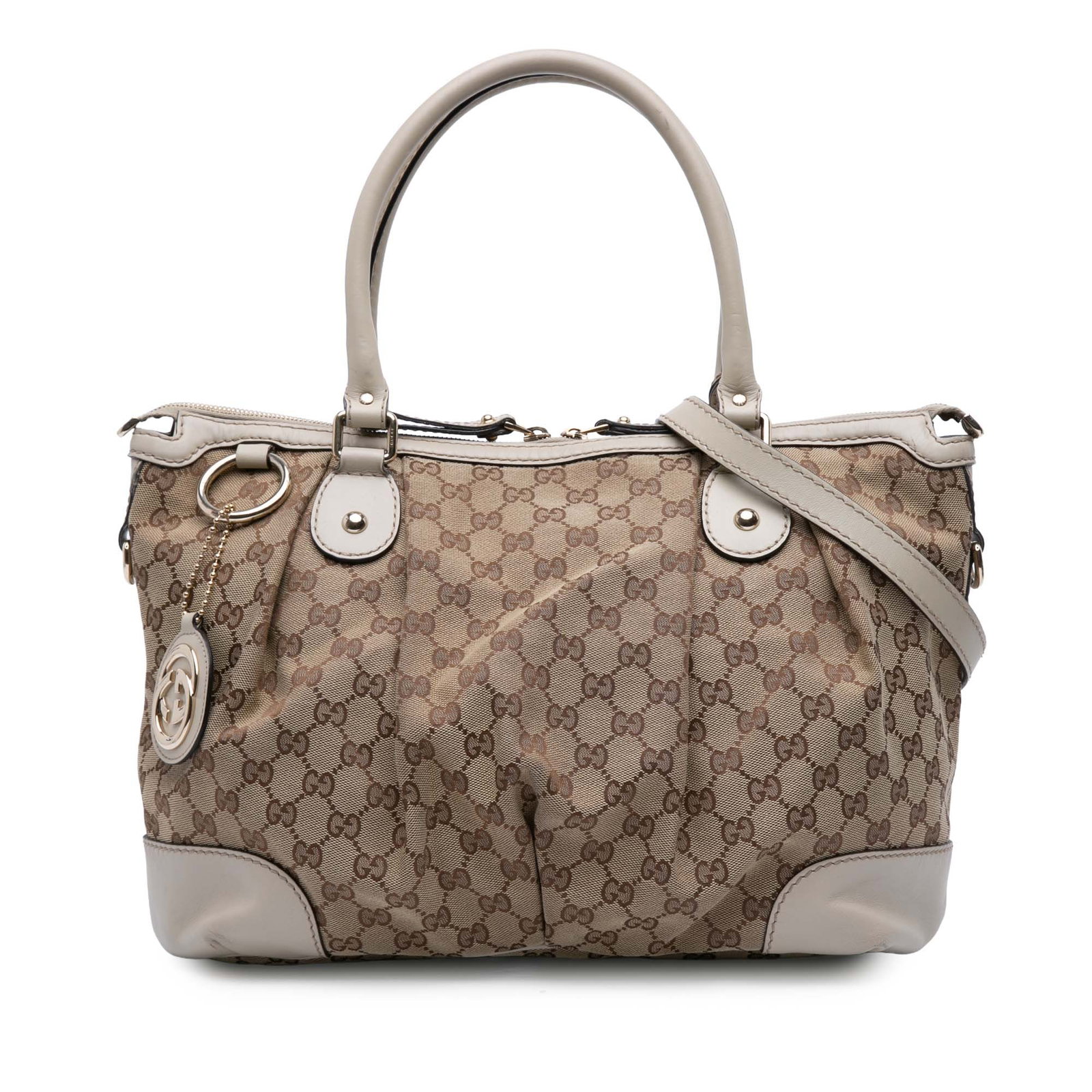 Gucci Sukey Beige GG Canvas Satchel with Leather Trim and Strap: Gucci Sukey Beige GG Canvas Satchel with Leather Trim and Strap The Gucci GG Canvas Sukey Satchel features a beige canvas body with leather trim, rolled leather handles, and a detachable flat leather 