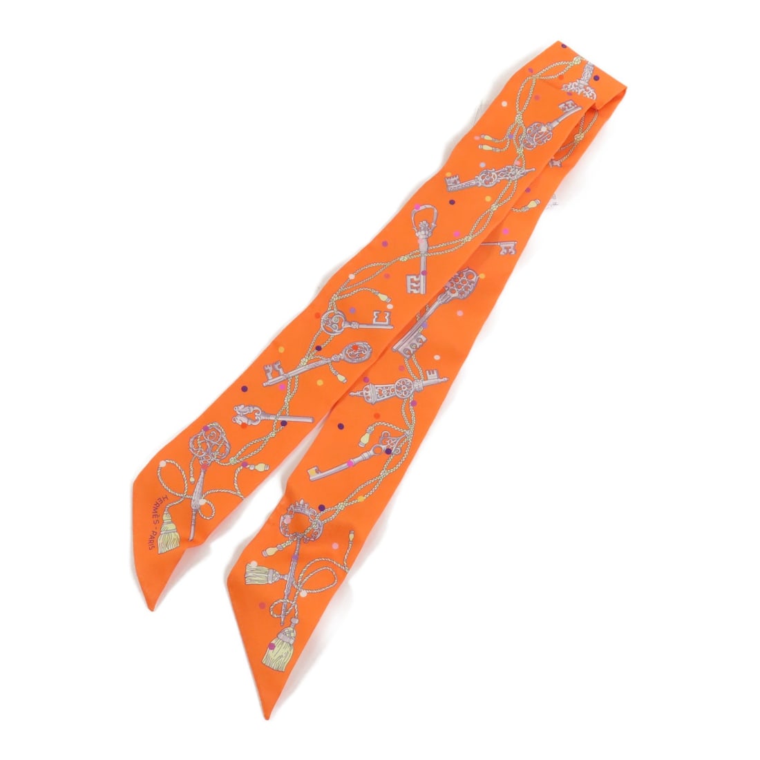 Silk Twilly Scarf by Hermes in Orange Multicolor: Silk Twilly Scarf by Hermes in Orange Multicolor This Hermes Twilly scarf is crafted from luxurious silk in an orange multicolor design. Made in France, it features a regular size and is designed for 