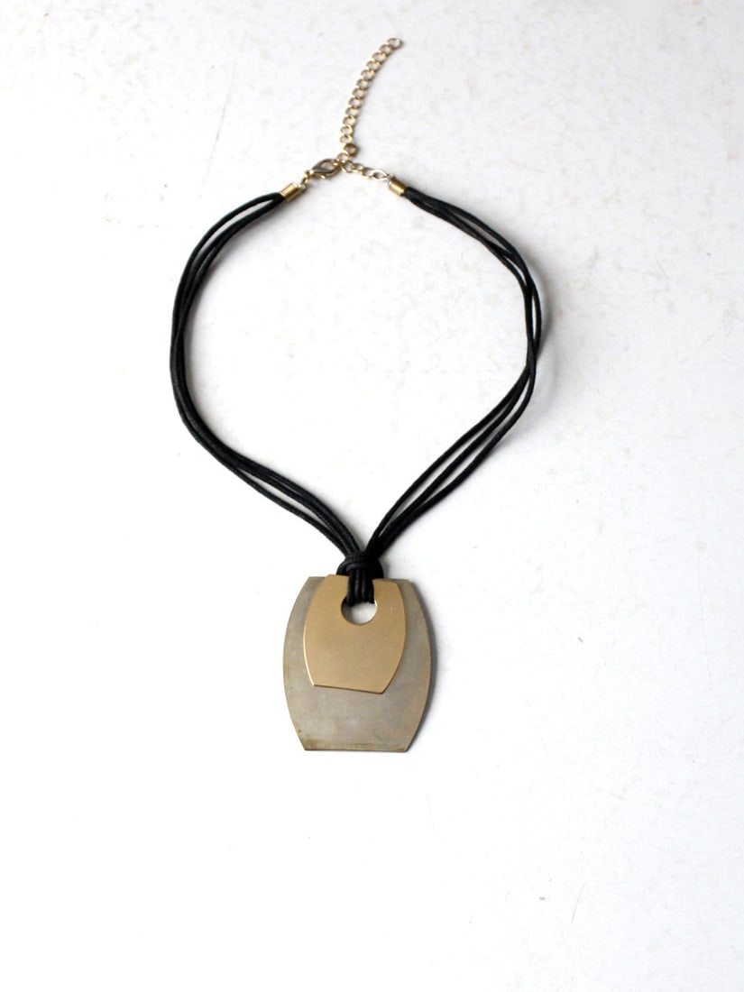 Vintage Mixed Metal Pendant Necklace Black Leather Chain: Vintage Mixed Metal Pendant Necklace Black Leather Chain Discover the charm of this vintage mixed metal pendant necklace. Featuring a striking pendant crafted in silver and gold tones, this piece is s
