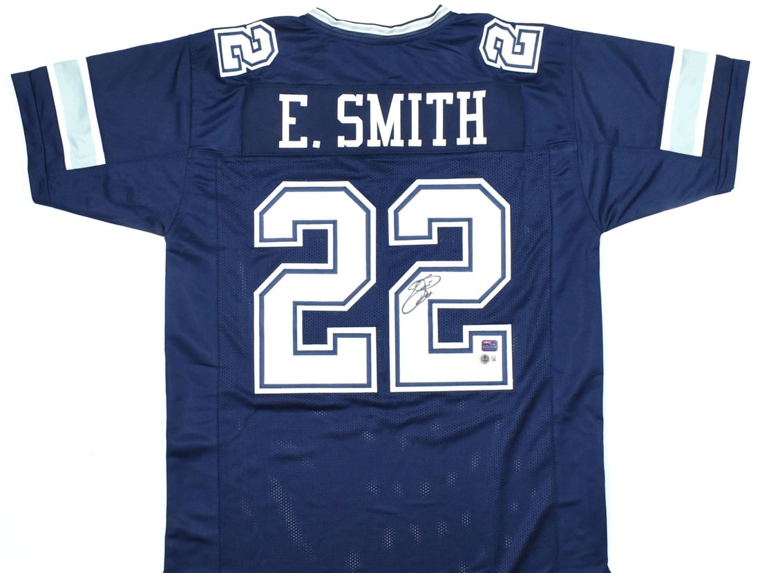 Emmitt Smith Signed Football Jersey with Beckett Hologram: Emmitt Smith Signed Football Jersey with Beckett Hologram This is a blue pro style jersey autographed by Emmitt Smith. The jersey is an original item representing the Dallas Cowboys, authenticated wit