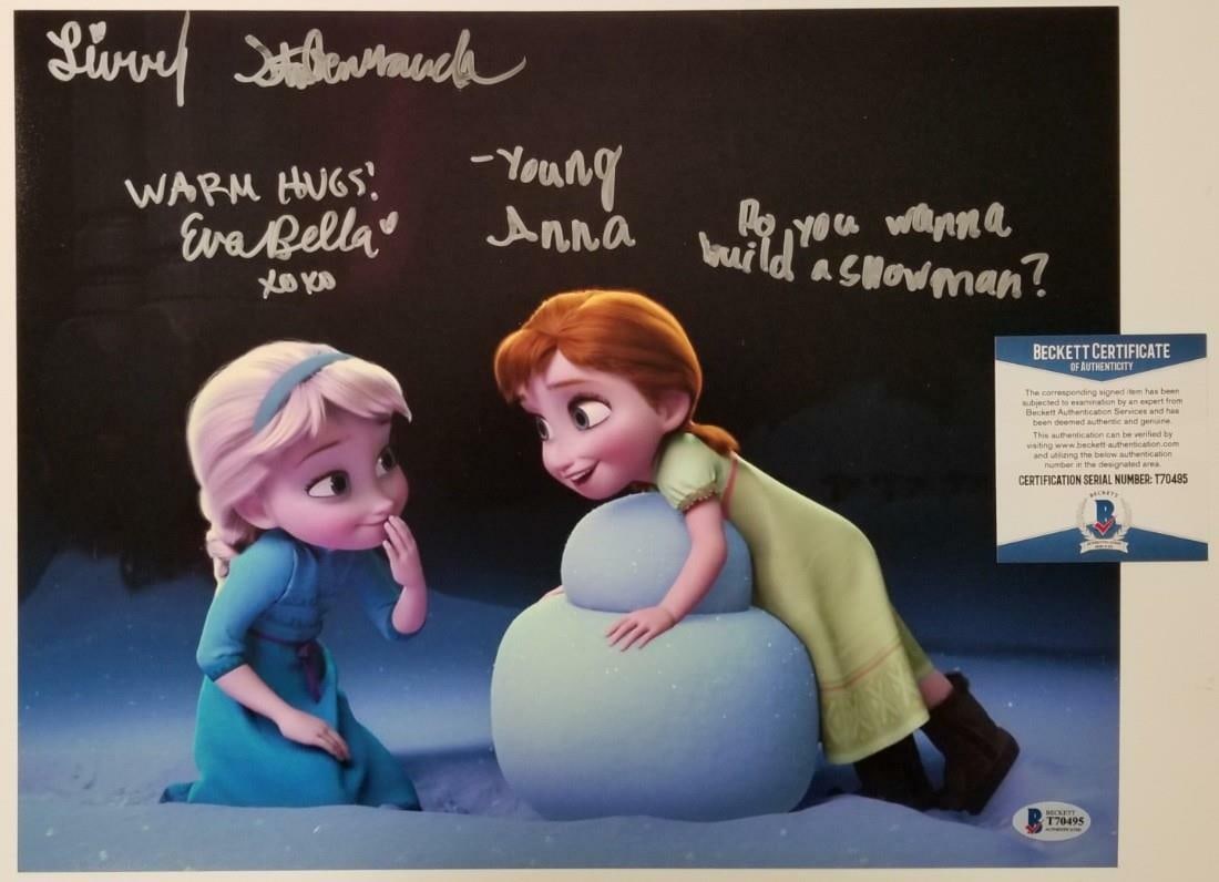 Signed 11x14 Frozen Photograph by Eva Bella and Livvy Stubenrauch BAS Authenticated: Signed 11x14 Frozen Photograph by Eva Bella and Livvy Stubenrauch BAS Authenticated This is an original 11x14 photograph from Disney's Frozen, signed by Livvy Stubenrauch and Eva Bella, the voices of 