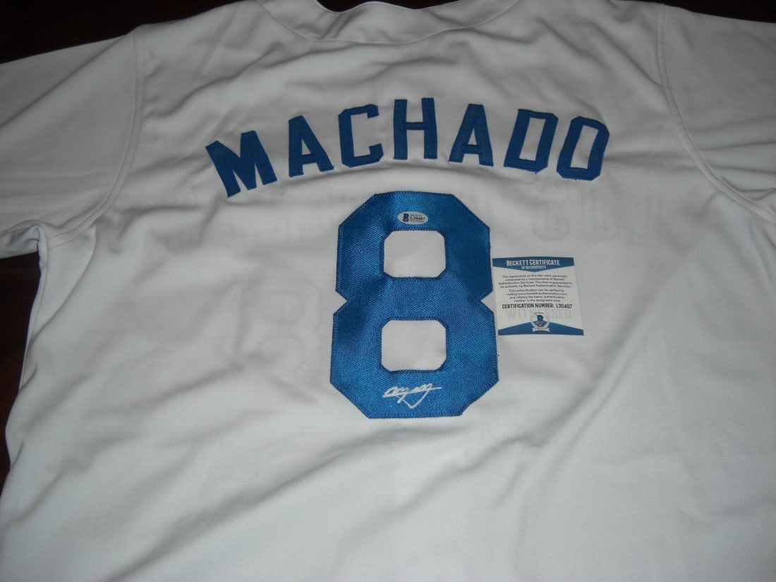 Signed Manny Machado Baseball Jersey with Beckett COA: Signed Manny Machado Baseball Jersey with Beckett COA This is a pre-owned Los Angeles Dodgers and Orioles jersey signed by Manny Machado. The jersey is an original item and is accompanied by a Beckett